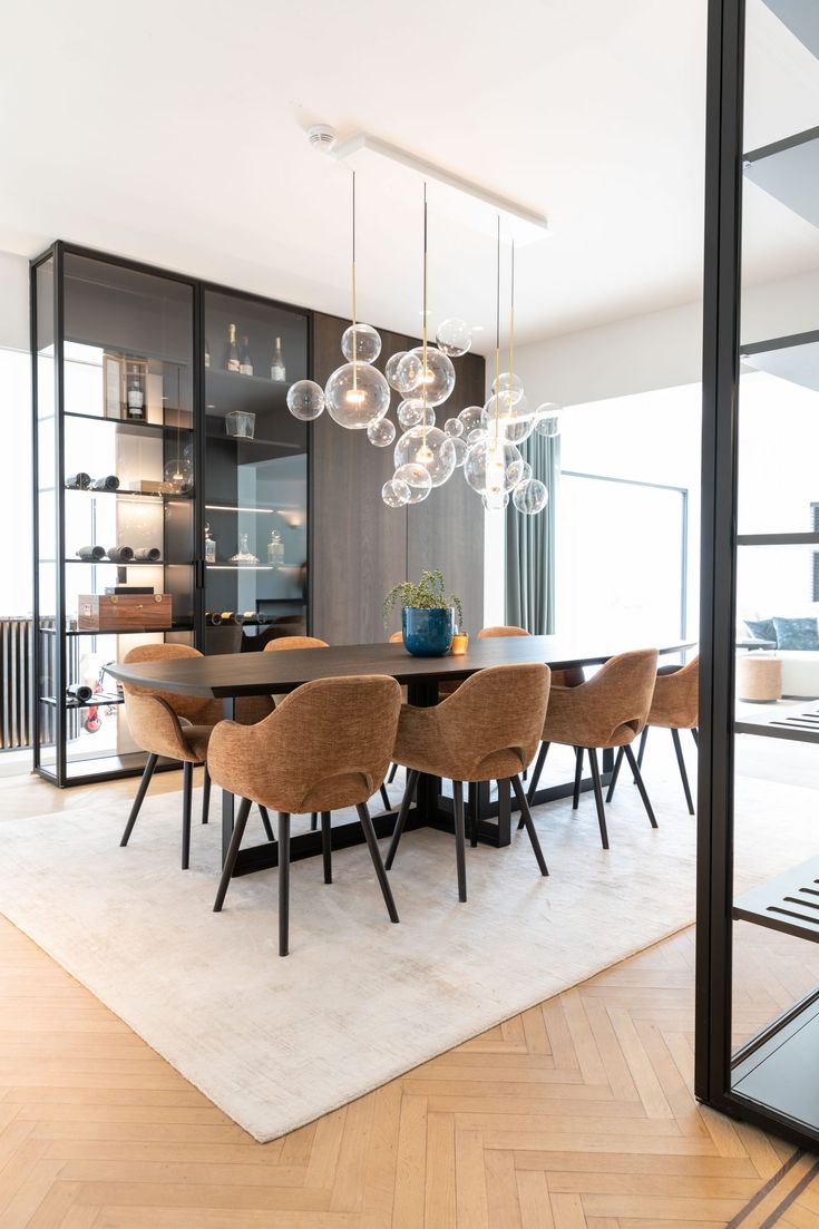 a dining room table with chairs and a chandelier