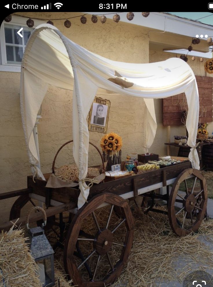 an old wagon is decorated with sunflowers and other things for the guests to eat