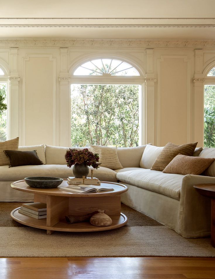 a living room filled with furniture and lots of windows in it's center area