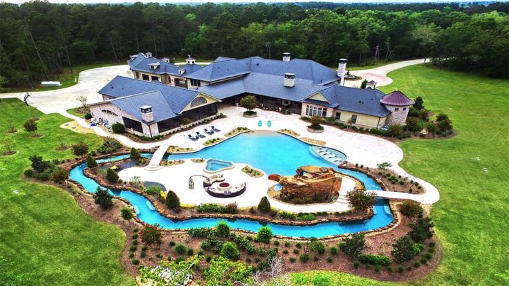 an aerial view of a large house with a pool