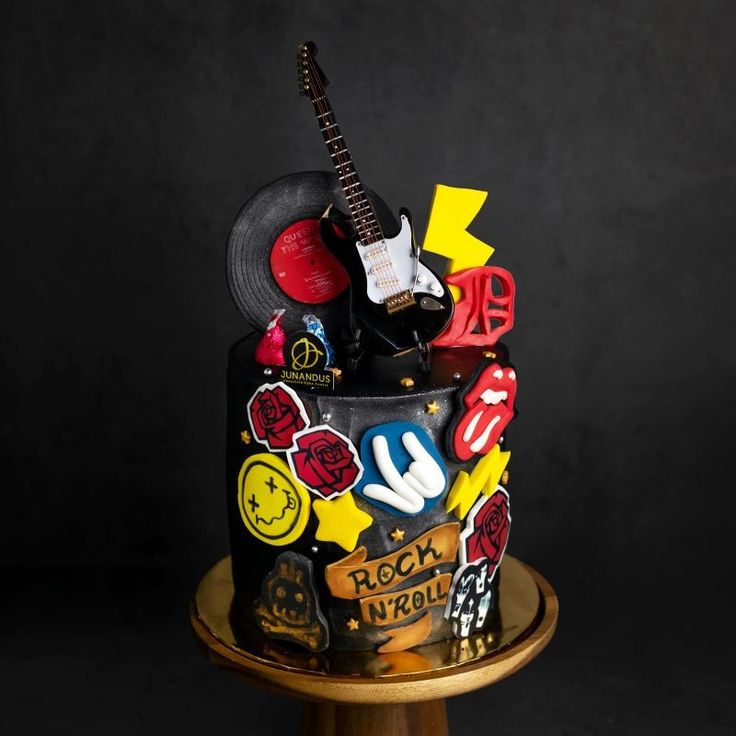 a birthday cake decorated with music memorabilia