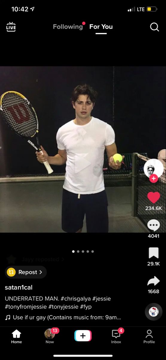 a man holding a tennis racquet on top of a tennis ball racket