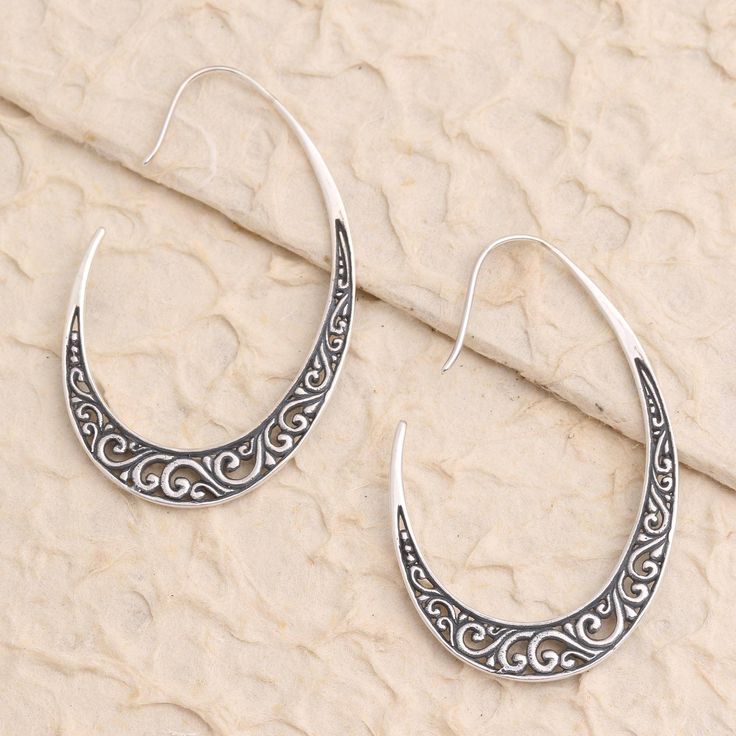 Pointed hooks of gleaming sterling silver swoop gracefully around your ear in these stunning drop earrings designed by Bali's Suar Dwipayana. Crafted from oxidized sterling silver the earrings are decorated with swirling tendrils in a traditional Balinese design. Teardrop Earrings With Fish Hook, Teardrop Fish Hook Earrings, Elegant Sterling Silver Hoop Earrings With French Hook, Elegant Sterling Silver Earrings With Fish Hook, Elegant Teardrop Earrings With Fish Hook, Sterling Silver Fish Hook Earrings, Silver Dangle Hoop Earrings With French Hook, Silver Sterling Hoop Earrings With French Hook, Silver Drop Earrings With Fish Hook