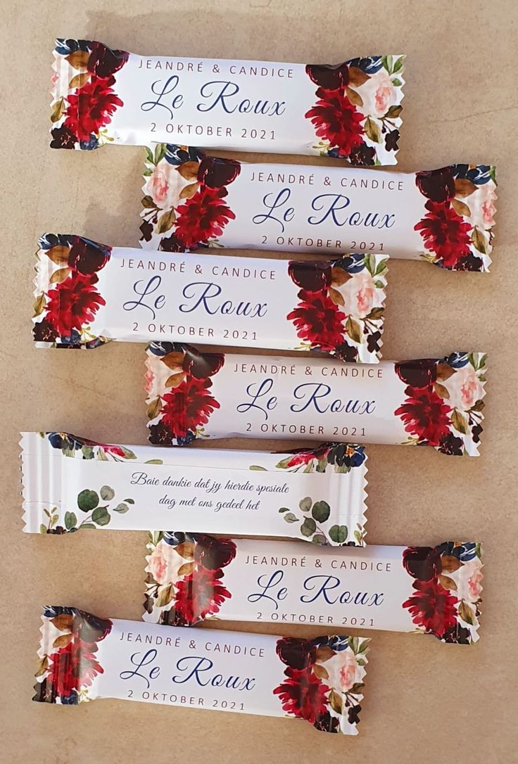 four candy bars with red flowers on them