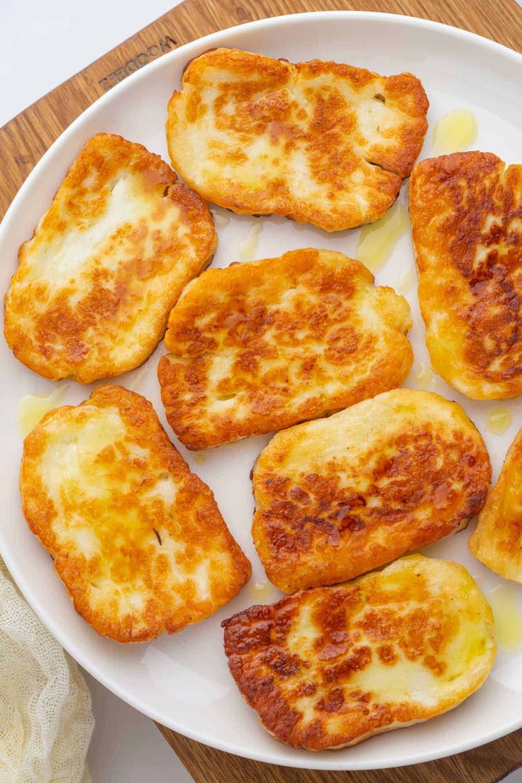 several pieces of fried cheese on a white plate