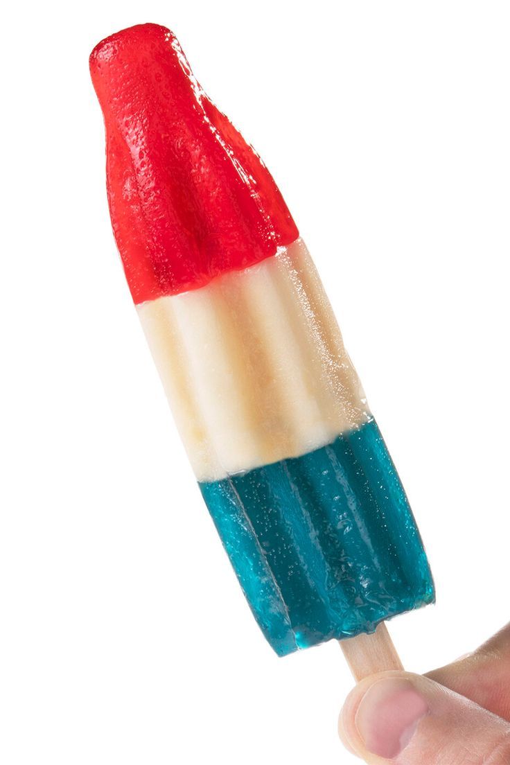 a hand holding an ice cream popsicle with red, white and blue toppings