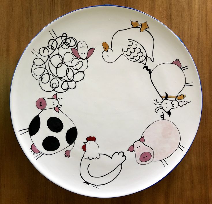 a plate with farm animals painted on it