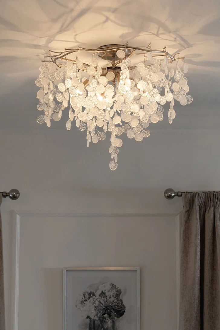 a chandelier hanging from the ceiling in a room