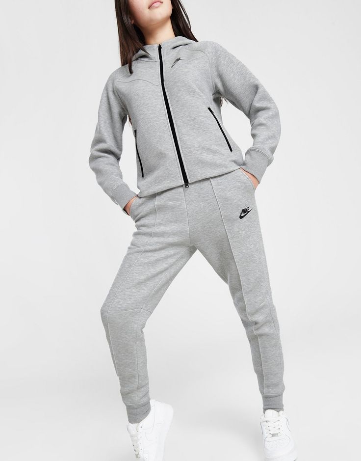 Max out your comfort with the Swoosh and rep these junior girls' Tech Fleece Joggers from Nike. In a Dark Grey Heather colourway, these standard fit joggers are cut from Nike's famous Tech Fleece fabric for a warm, cosy wear. They feature an elasticated, drawcord waistband, with ribbed cuffs for showing off your sneaks. They have side pockets for storage and are finished up with a Futura logo to the leg. Machine washable. Tech Fleece Girl, Grey Tech Fleece, Fame Clothes, Fitted Joggers, Nikes Girl, Tech Fleece, Grey Nikes, Fleece Joggers, Jd Sports