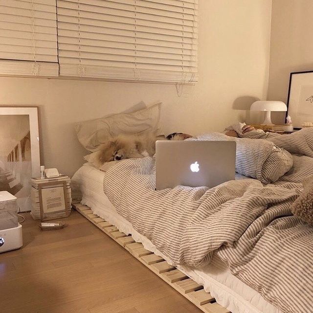 an open laptop computer sitting on top of a bed