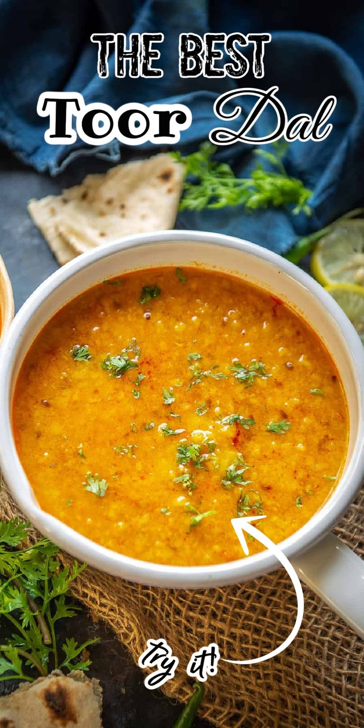 the best toor dad soup recipe in a white bowl on top of a table with pita bread