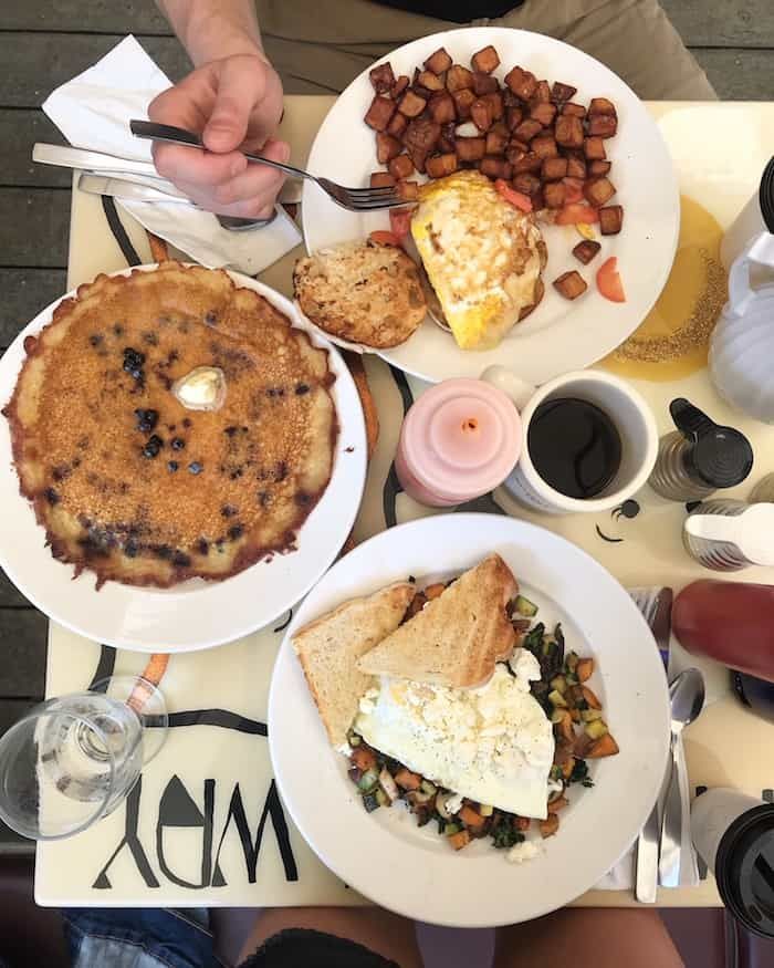 a table topped with plates of food and drinks