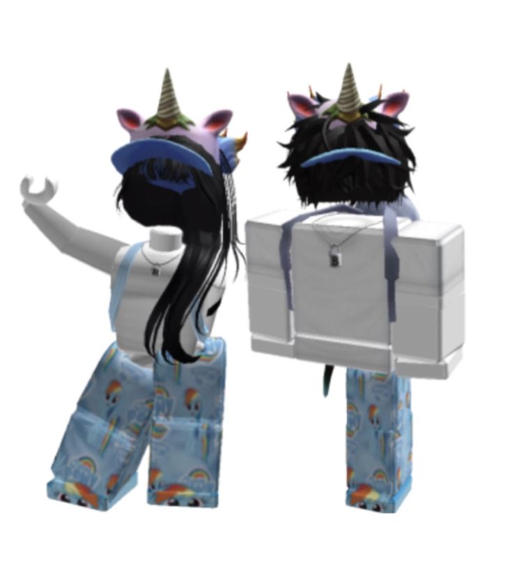 two dolls are dressed in pajamas and unicorn hats, one is holding a suitcase while the other holds a box