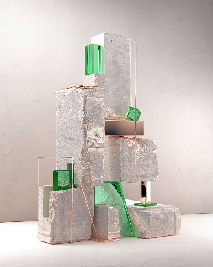 an artistic sculpture made out of blocks and green glass pieces on top of each other