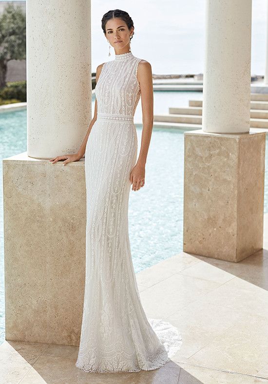 a woman standing in front of a pool wearing a white dress