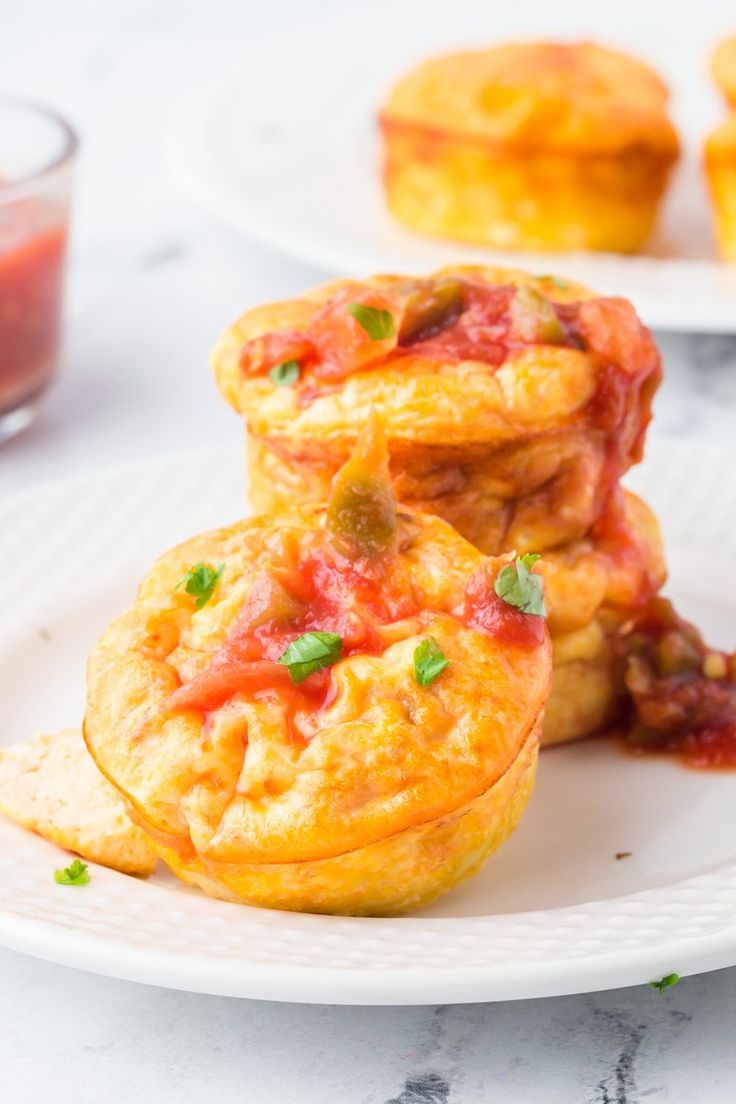 three small muffins on a white plate