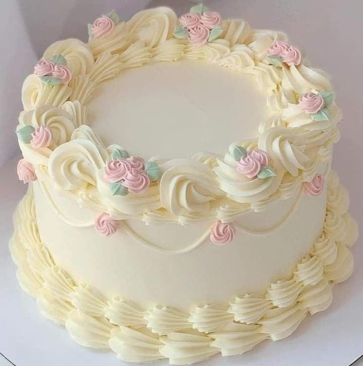 a white cake with pink and green flowers on it