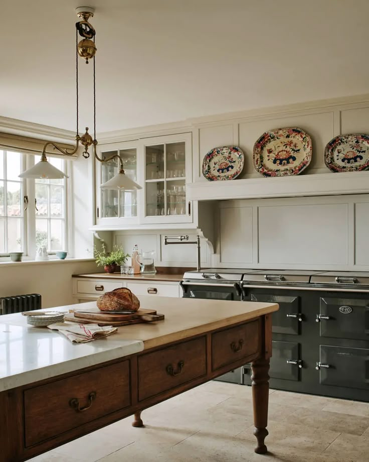 a kitchen with an island in the middle and two plates on the wall above it