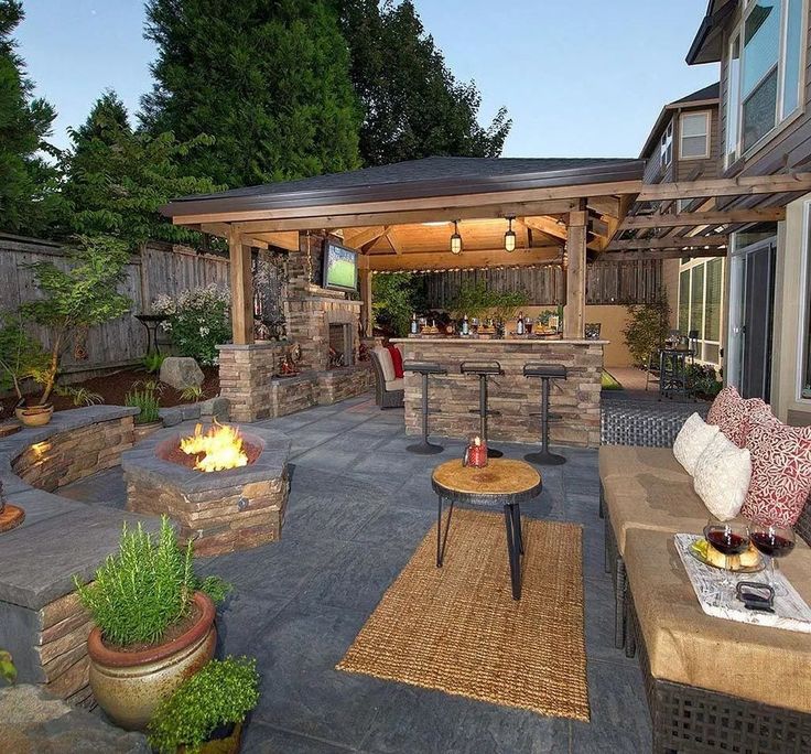 an outdoor living area with fire pit and seating