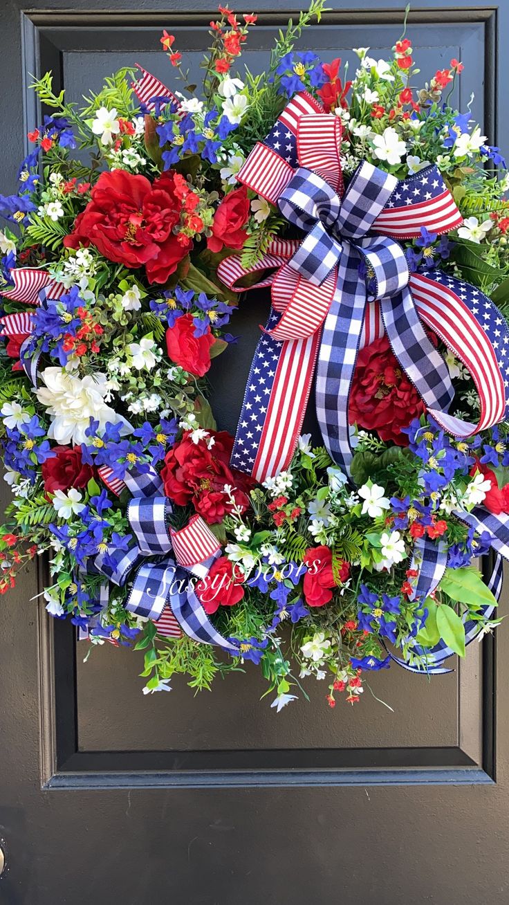 a patriotic wreath with red, white and blue flowers