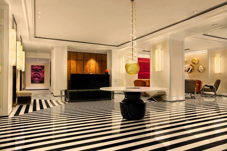 a black and white striped floor in a living room with chandelier above the table