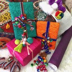 several colorful wrapped presents sitting on top of a white furnishing covered floor next to decorative items