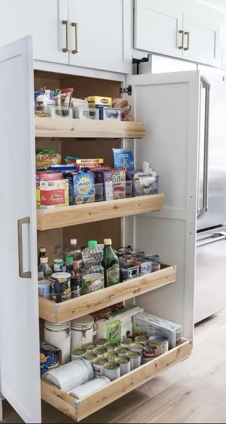 an open refrigerator door in a kitchen filled with food