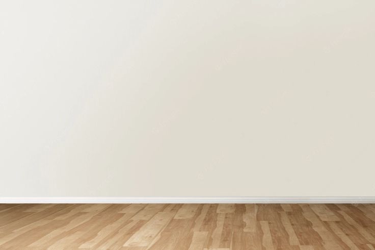 an empty room with white walls and wooden floors