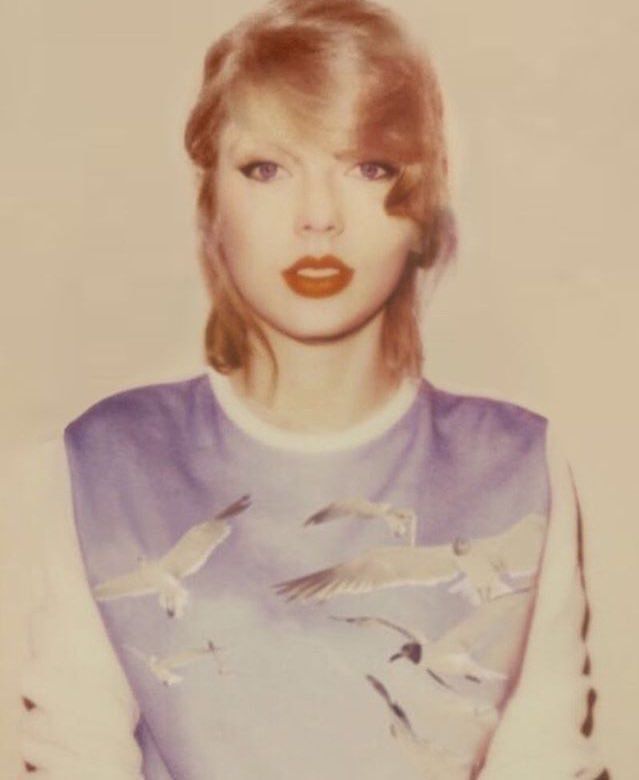 an old photo of a woman with birds on her shirt and red lipstick in the foreground