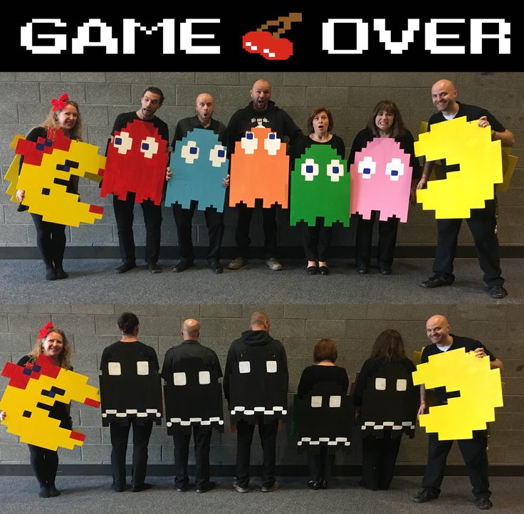 some people are holding up paper pacman and pac man costumes that say game over