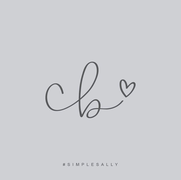 the word love is written in cursive handwriting on a gray background with a heart