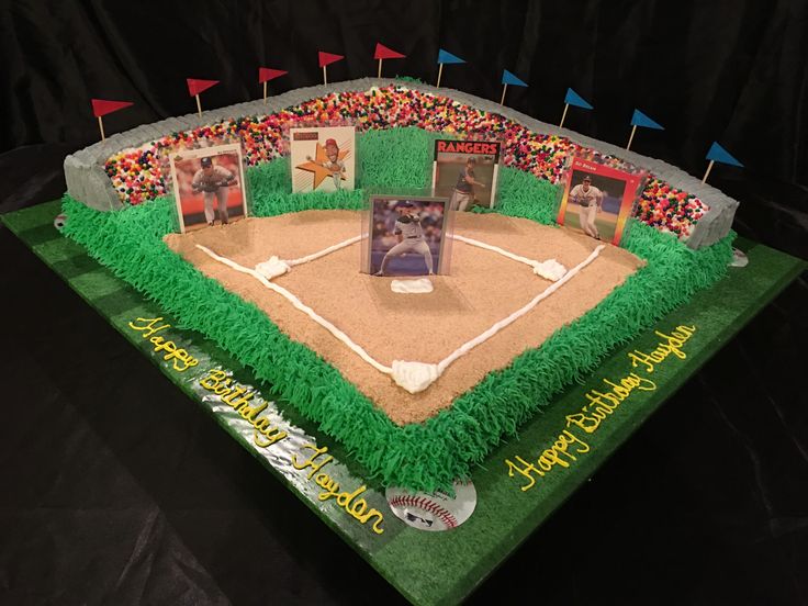 a cake that looks like a baseball field with pictures and flags on the top tier