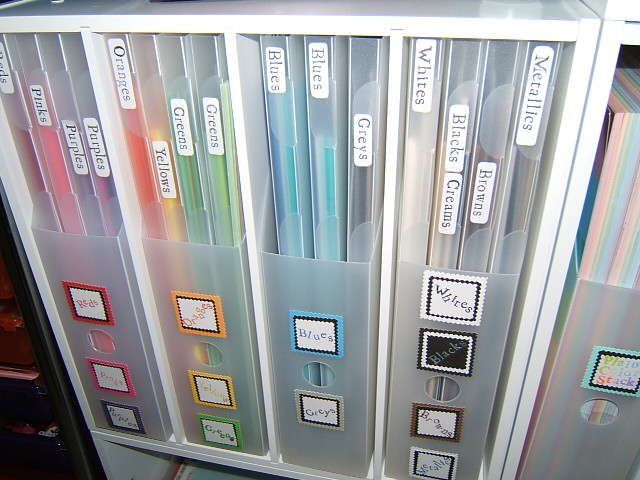 several files are stacked on top of each other in clear plastic cases with colored labels