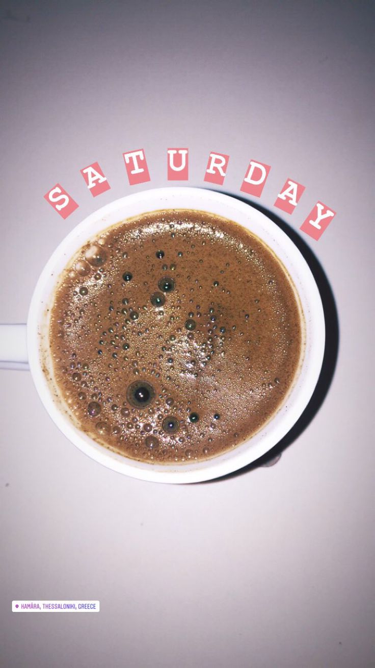 a cup of coffee with the word saturday written in red and white letters on it