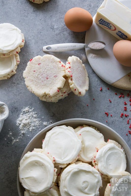 some cookies are sitting in a bowl with white frosting