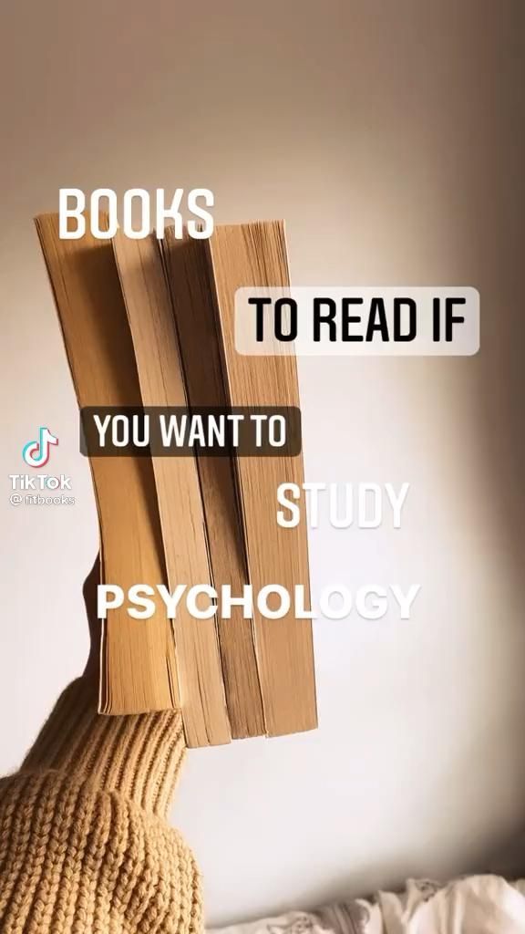 a person's hand holding books up to read if you want to study psychology