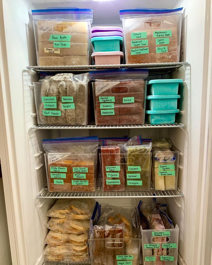 a refrigerator filled with lots of food and plastic containers on the shelves, all labeled with labels