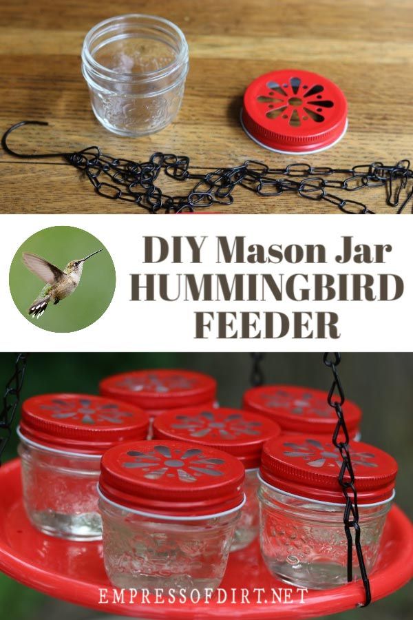 mason jar hummingbird feeder with red lids and chain hanging from the bottom, on a wooden table