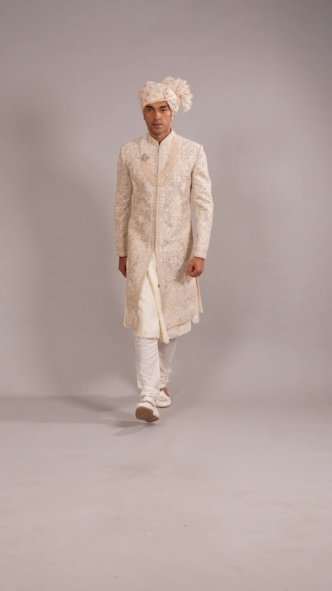 Your bride will be mesmerized just by looking at you when you wear this awesome raw silk cream peshwai sherwani. The cream-colored peshwai kurta and the embroidery, resham, beads, pearls, stone, and zardoshi work increase the grace of the sherwani. It comes along with matching bottom.