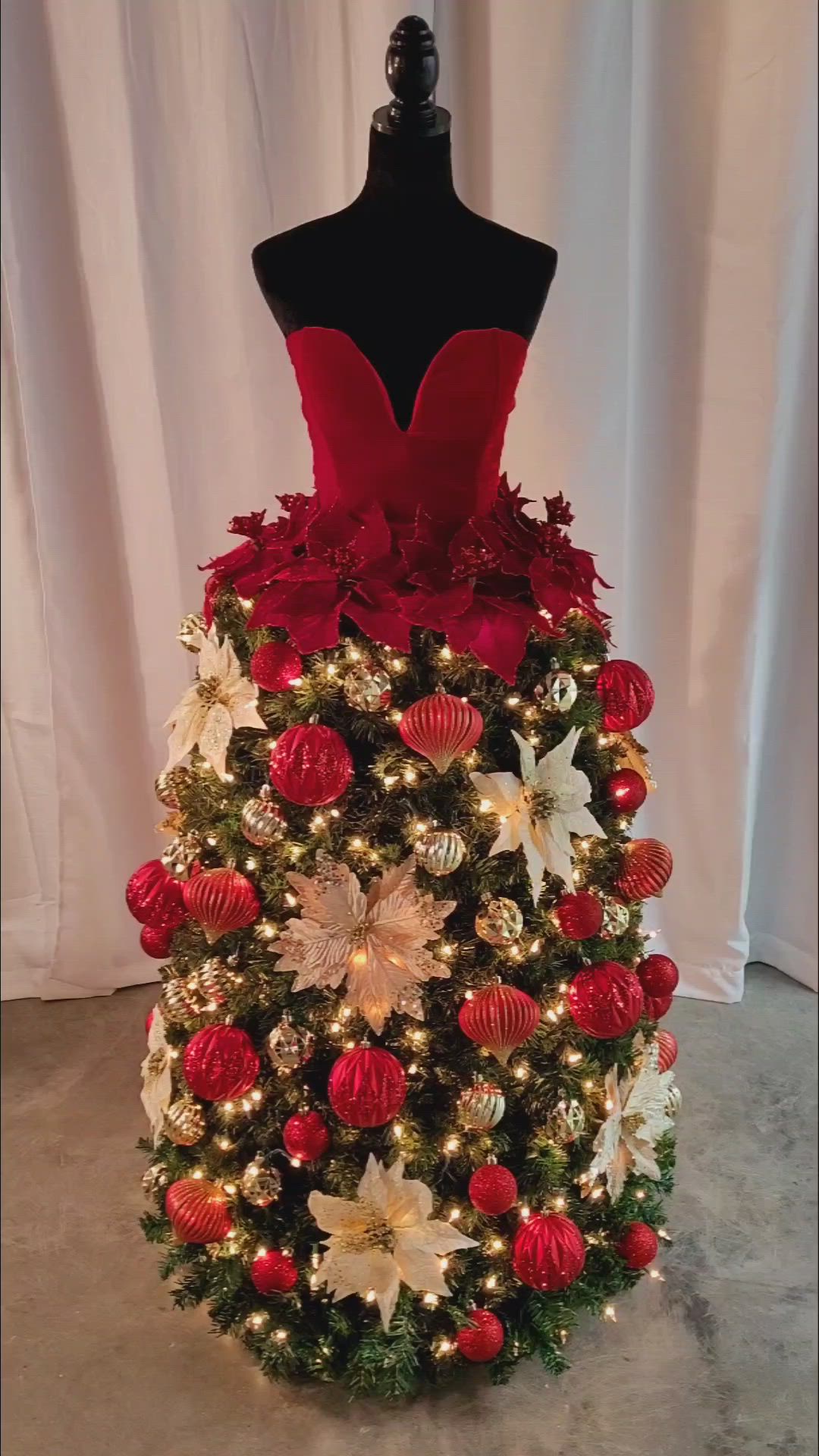 This may contain: a mannequin is decorated with red and white christmas decorations, including poinsettis