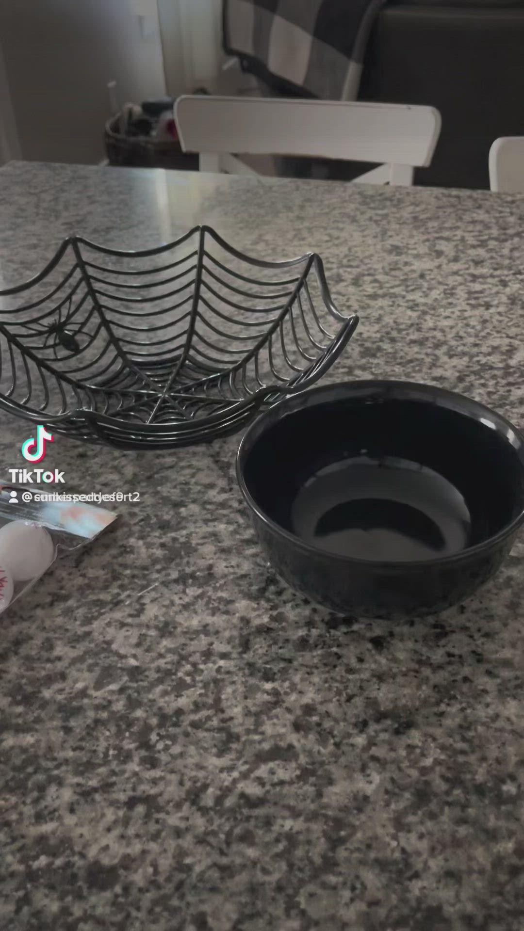 This may contain: a black bowl sitting on top of a counter next to a spider web dish rack