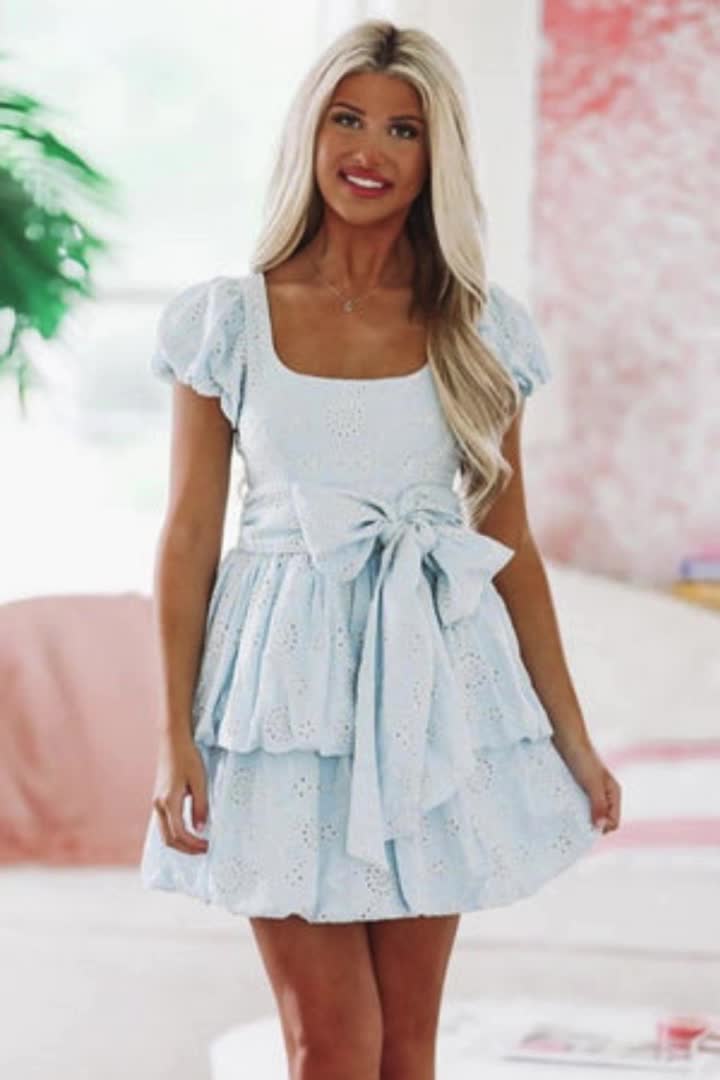 This mini dress is stunning with its eyelet fabric, We love the tiered ruffle skirt and the puff sleeves. Fit: True to Fit. Model is 5'7 wearing size small.