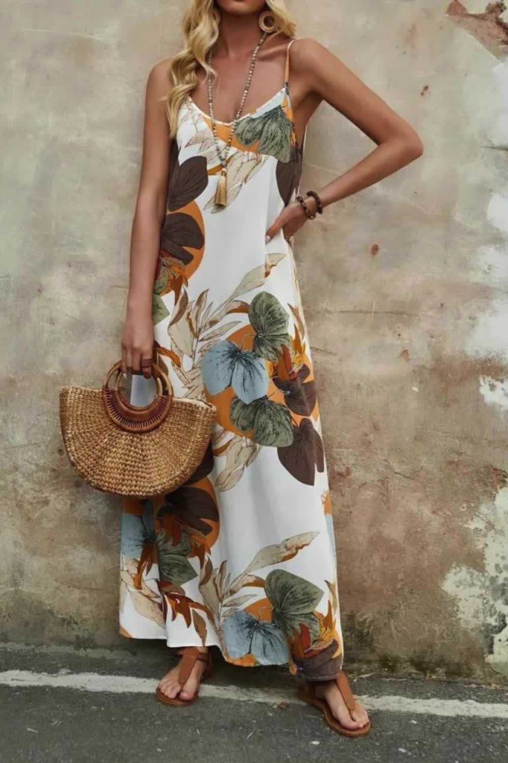 "Capture the essence of spring and summer in this stunning plant print spaghetti strap maxi dress. With its vacation-ready sleeveless design and flattering V-neckline, it's the epitome of effortless style. Perfect for sunny days and beach getaways, this dress radiates laid-back elegance and charm."