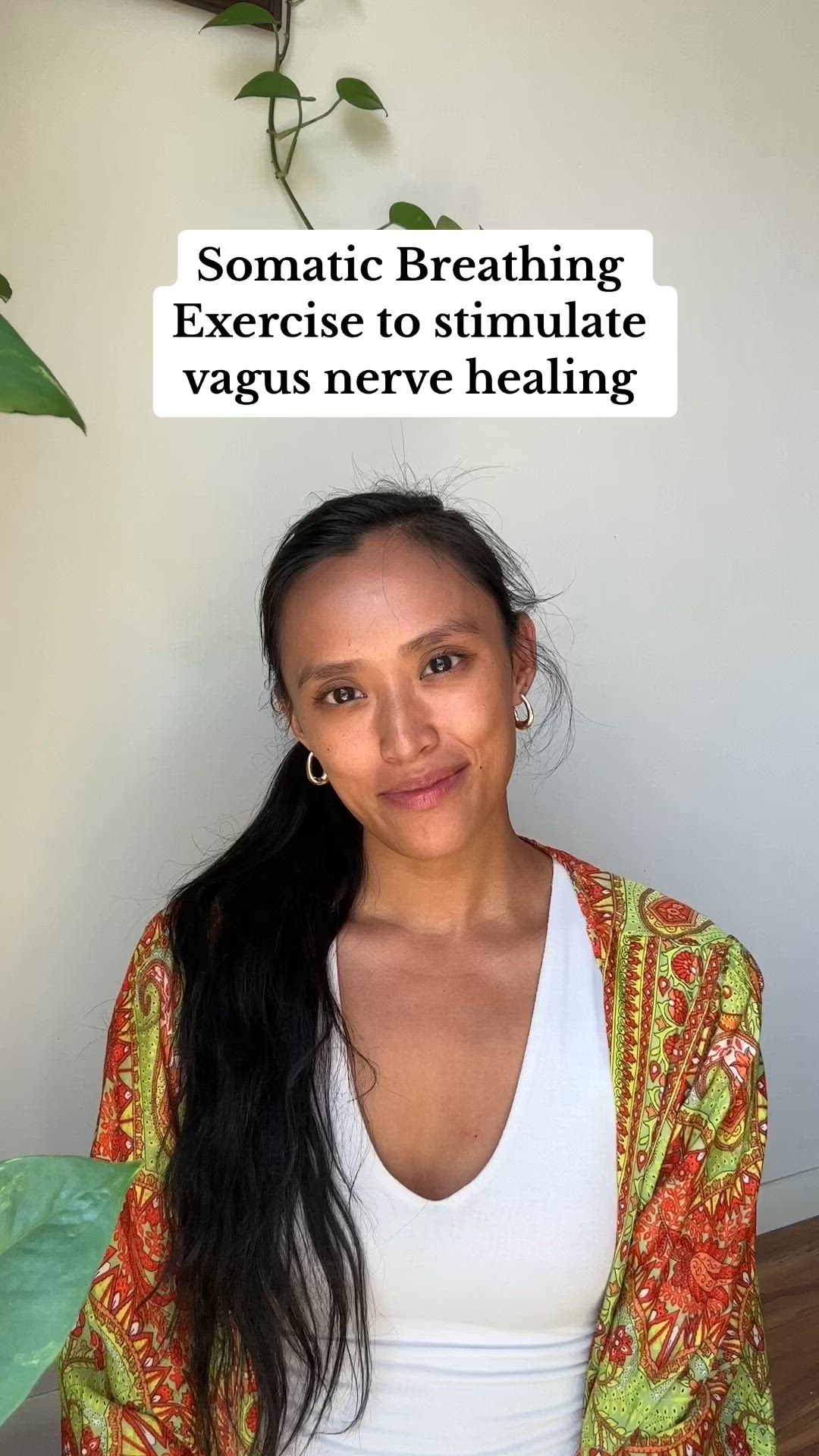 This may contain: a woman with her hands together in front of her face and the words, somatic breathing exercise to simulate vagus nerve healing