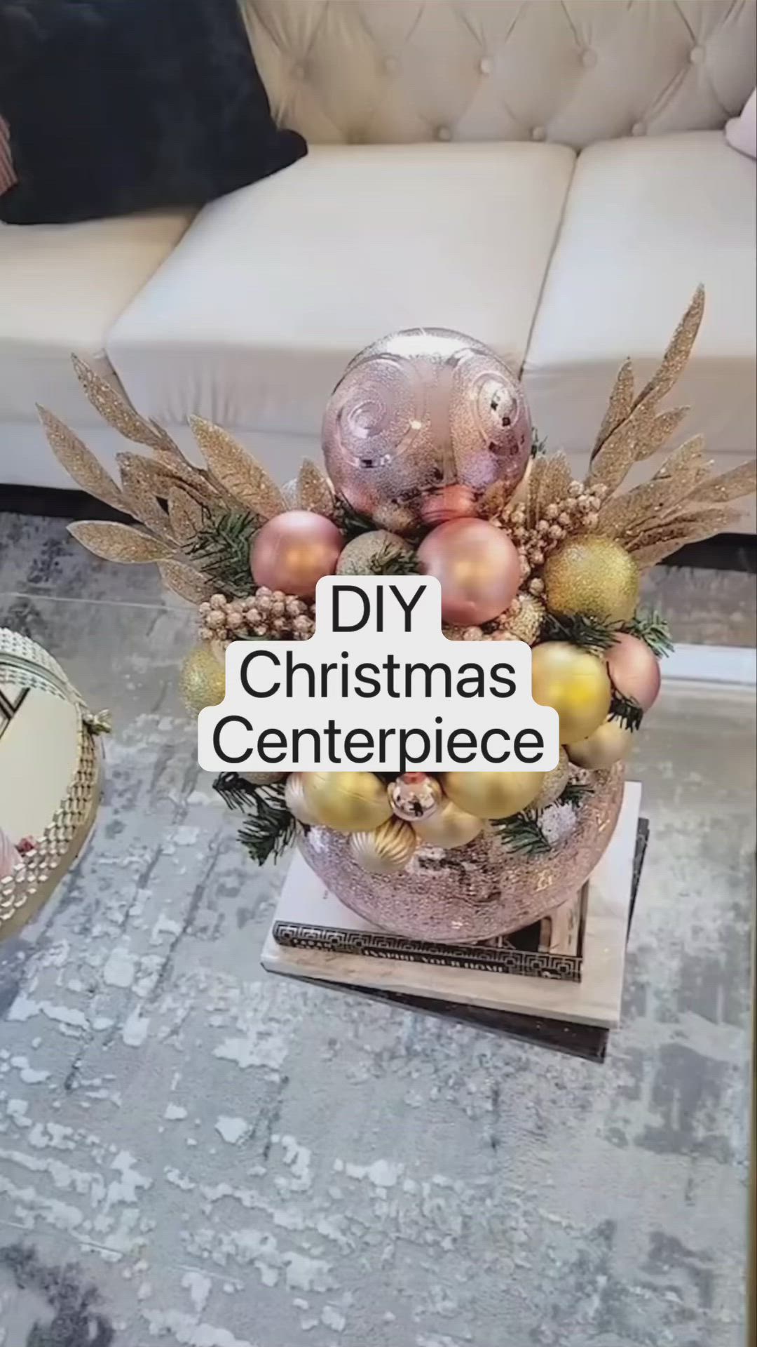 This may contain: a christmas centerpiece sitting on top of a wooden table next to a white couch