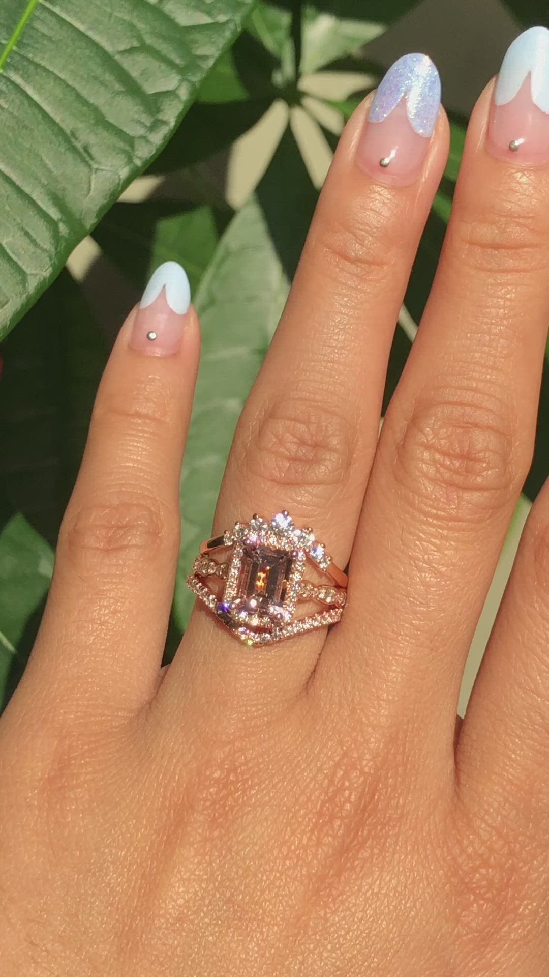 This may contain: a woman's hand with two different colored nails and a ring on her finger