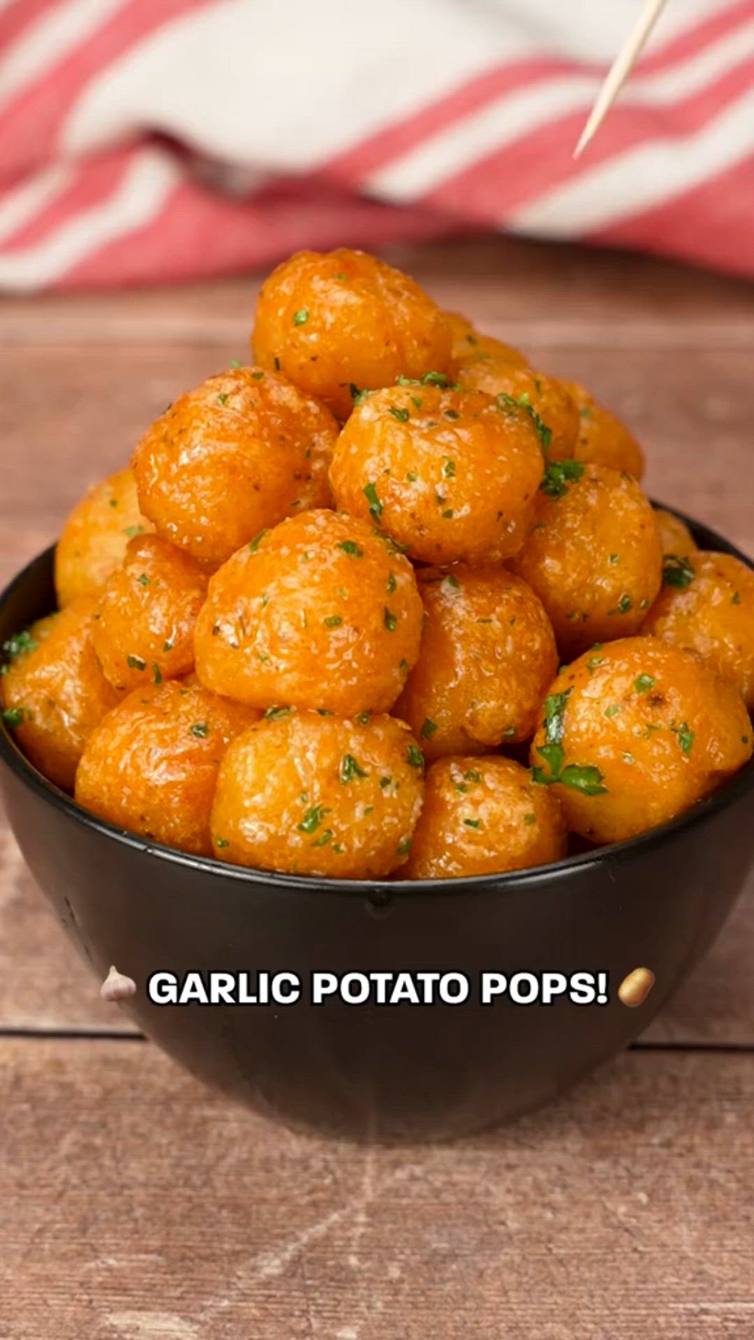 This contains: "Delicious Garlic Potato Pops on a serving platter, garnished with fresh herbs and spices"