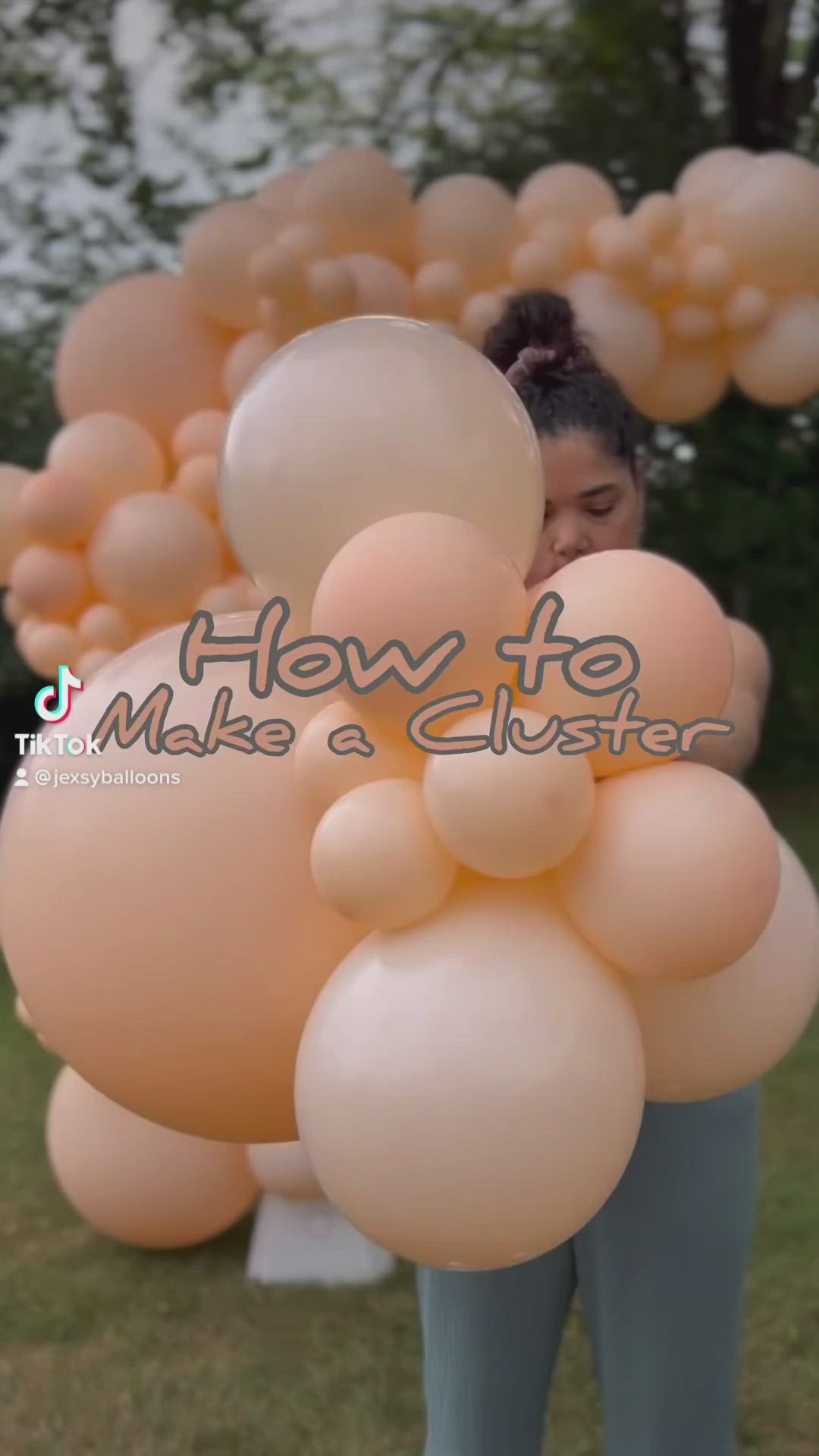 This may contain: a woman holding balloons in front of her face