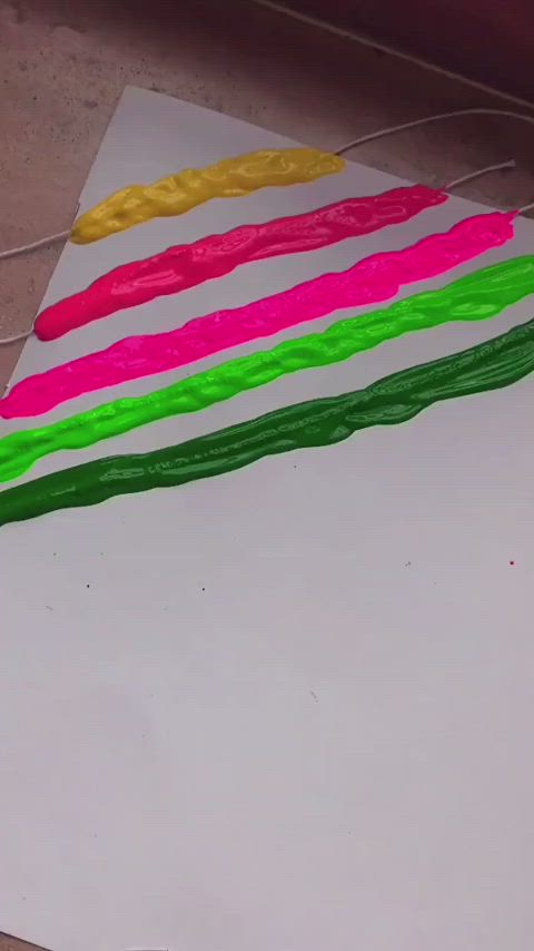 This may contain: a bunch of colorful candles sitting on top of a piece of paper next to a string