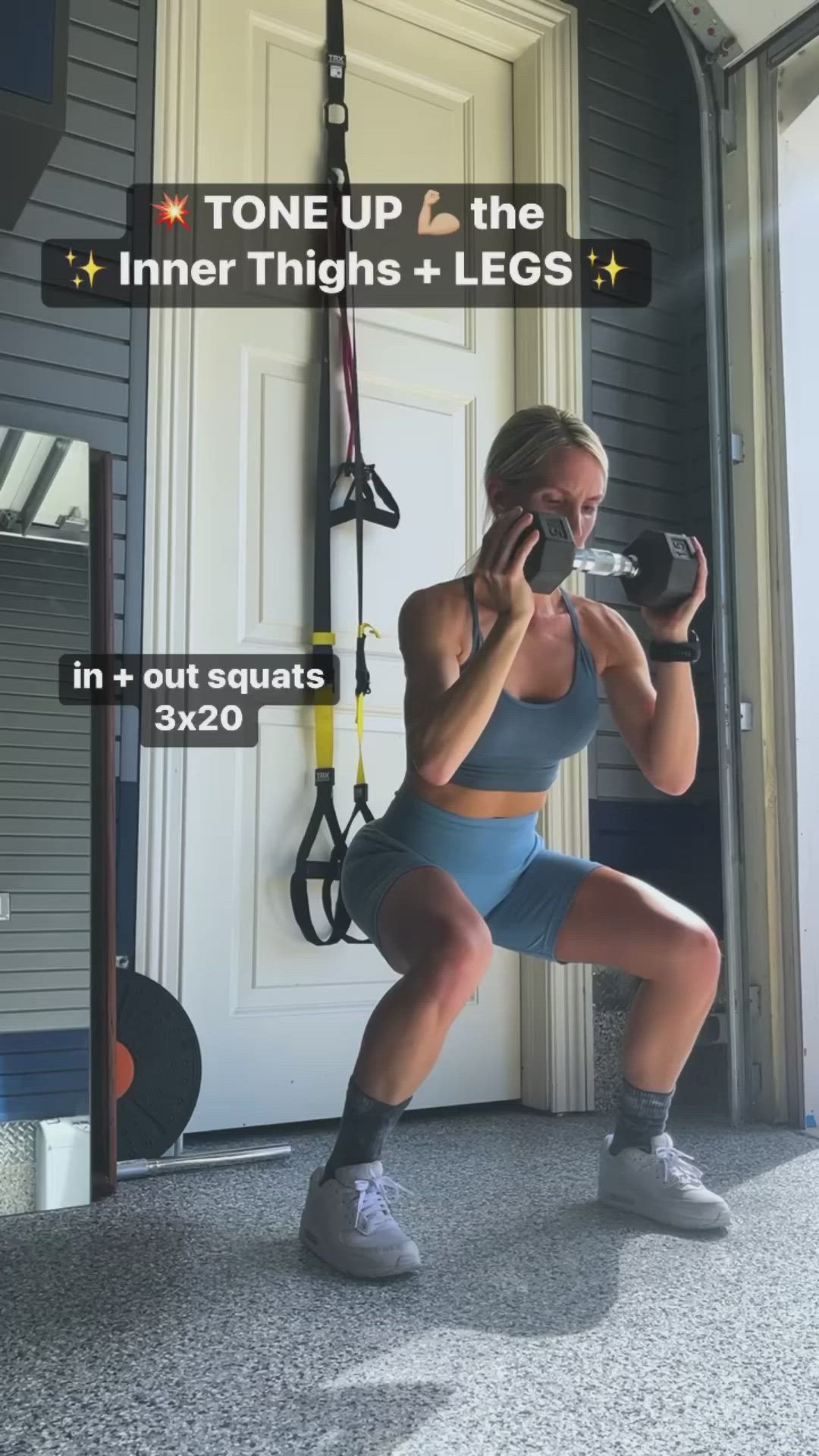 This may contain: a woman squats in front of a gym door while holding a water bottle and looking at her phone